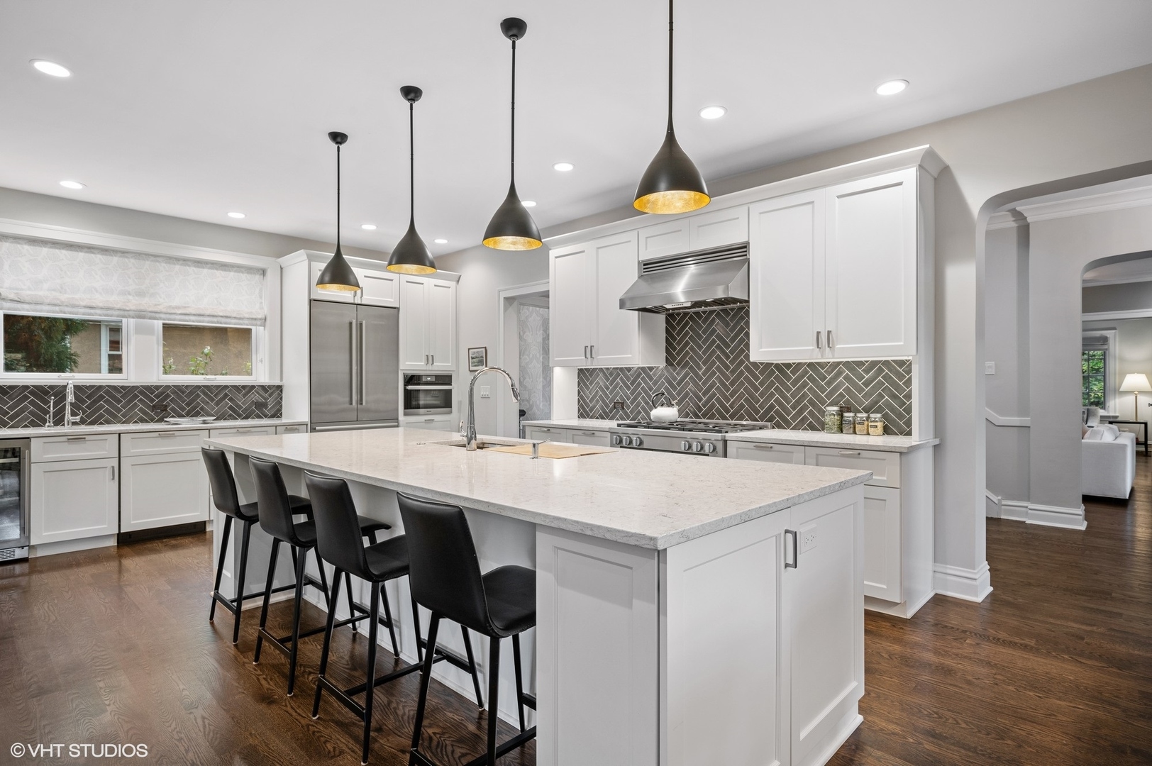 1002 Monroe Avenue River Forest, IL 60305 - Photo 8 of 31 a kitchen with stainless steel appliances a sink a stove a kitchen island with chairs and wooden floor