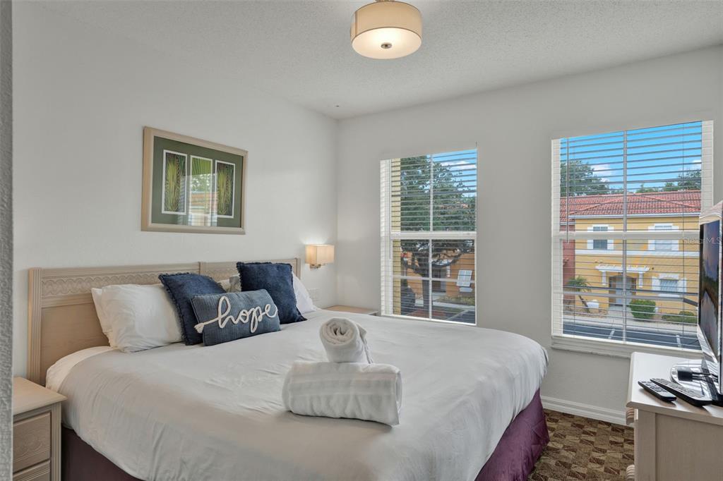 1086 Park Ridge Circle Kissimmee, FL 34746 - Photo 11 of 57 a bedroom with a bed and a large window