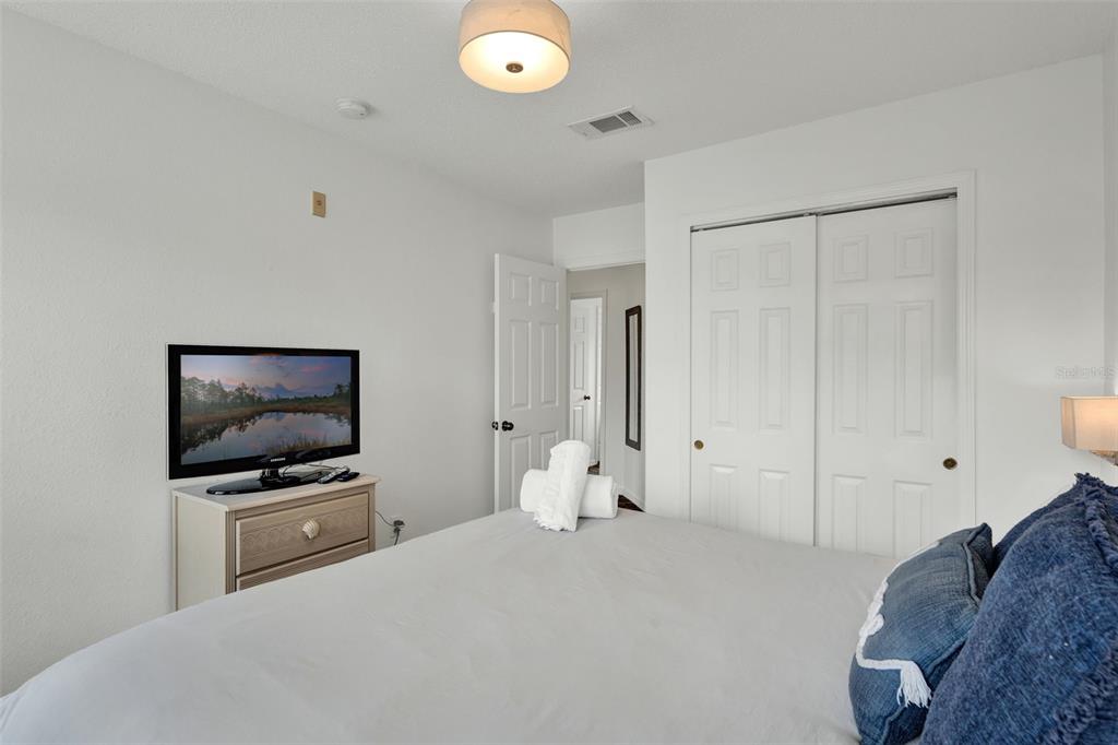 1086 Park Ridge Circle Kissimmee, FL 34746 - Photo 12 of 57 a bedroom with a bed and a flat screen tv