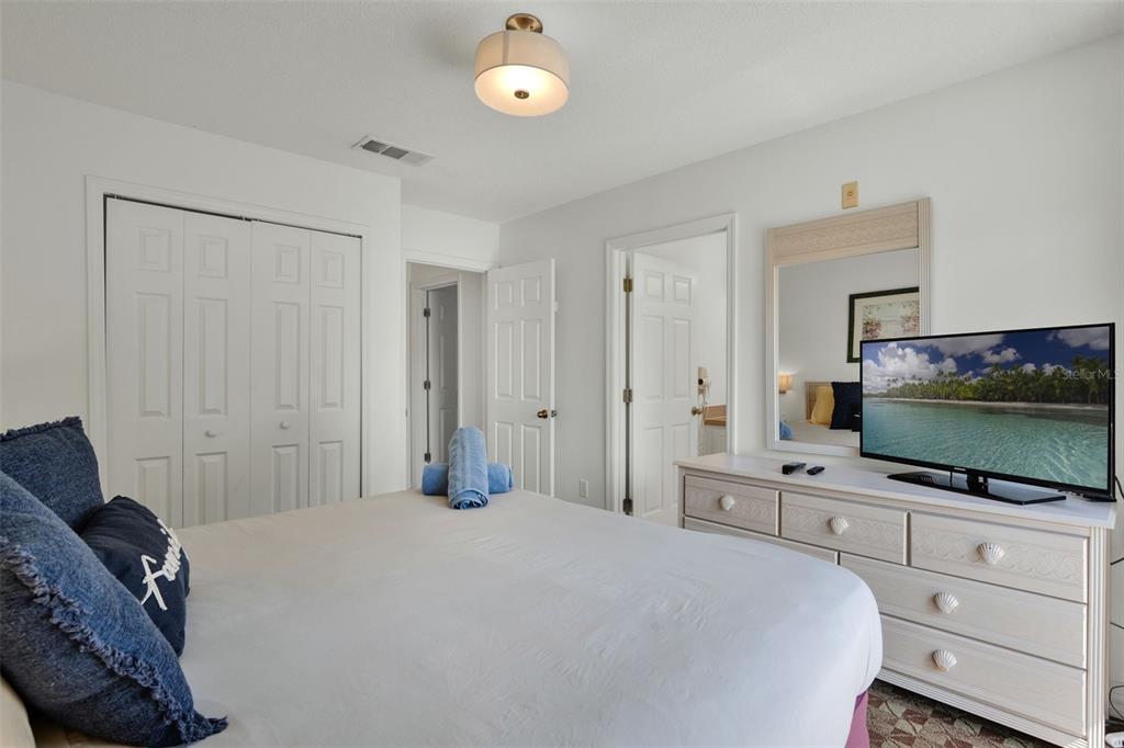 1086 Park Ridge Circle Kissimmee, FL 34746 - Photo 14 of 57 a bedroom with a bed and a flat screen tv