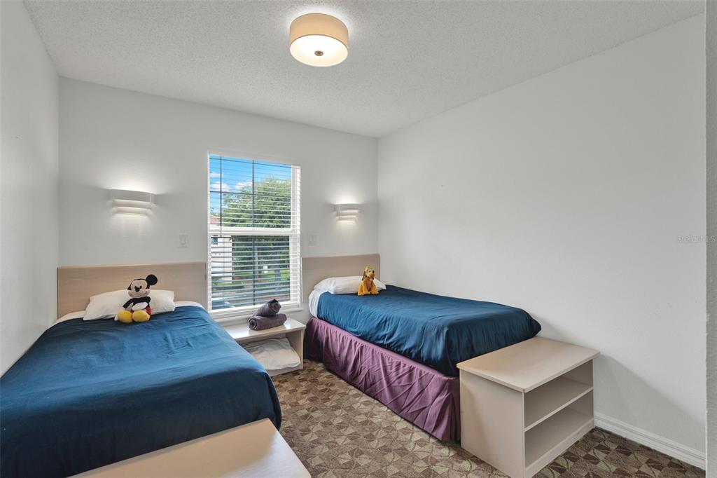 1086 Park Ridge Circle Kissimmee, FL 34746 - Photo 15 of 57 a bedroom with bed couch and window