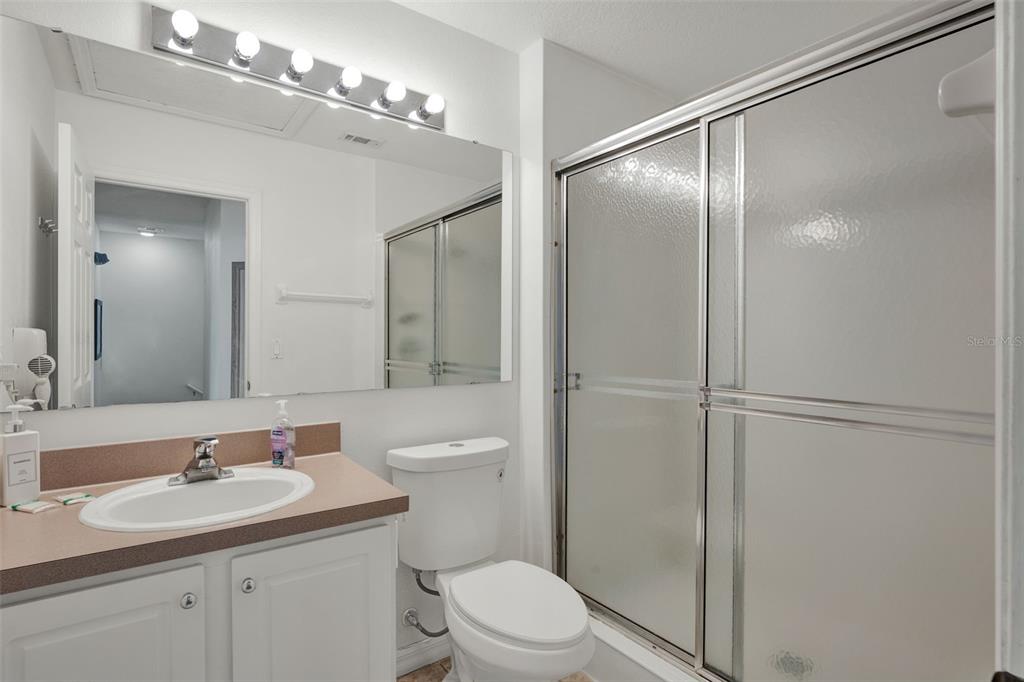 1086 Park Ridge Circle Kissimmee, FL 34746 - Photo 17 of 57 a bathroom with a toilet a sink and a mirror