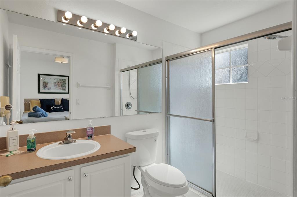 1086 Park Ridge Circle Kissimmee, FL 34746 - Photo 18 of 57 a bathroom with a sink toilet a mirror and shower