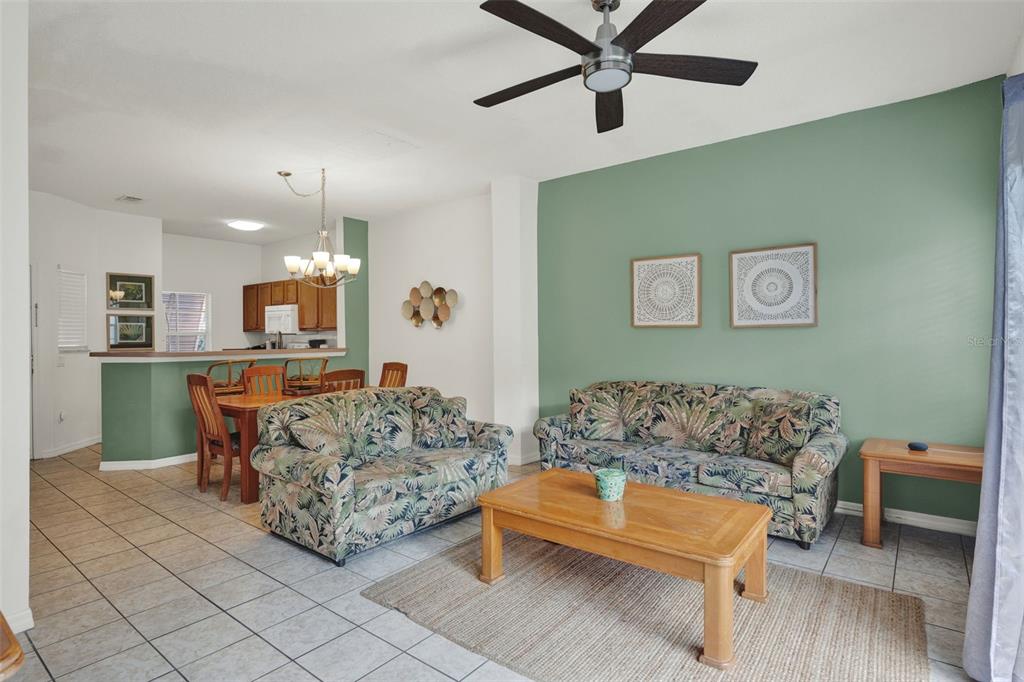 1086 Park Ridge Circle Kissimmee, FL 34746 - Photo 3 of 57 a living room with furniture and a view of kitchen