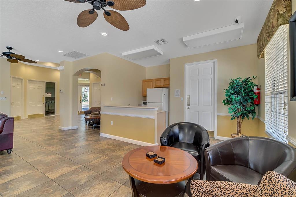 1086 Park Ridge Circle Kissimmee, FL 34746 - Photo 39 of 57 a living room with furniture and a chandelier