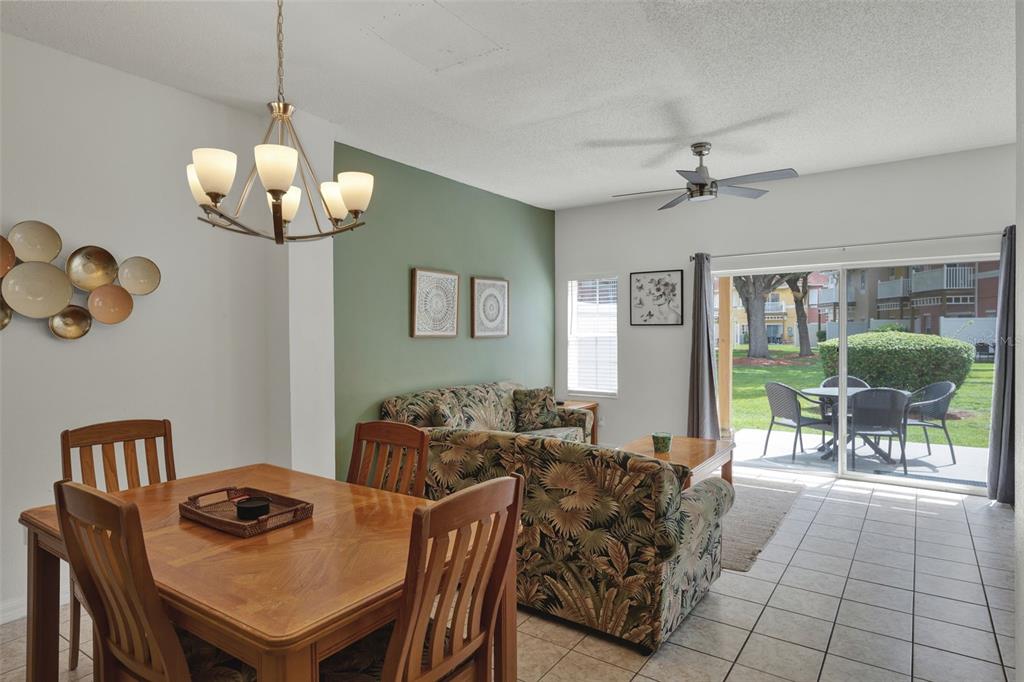 1086 Park Ridge Circle Kissimmee, FL 34746 - Photo 5 of 57 a view of a dining room with furniture wooden floor and chandelier