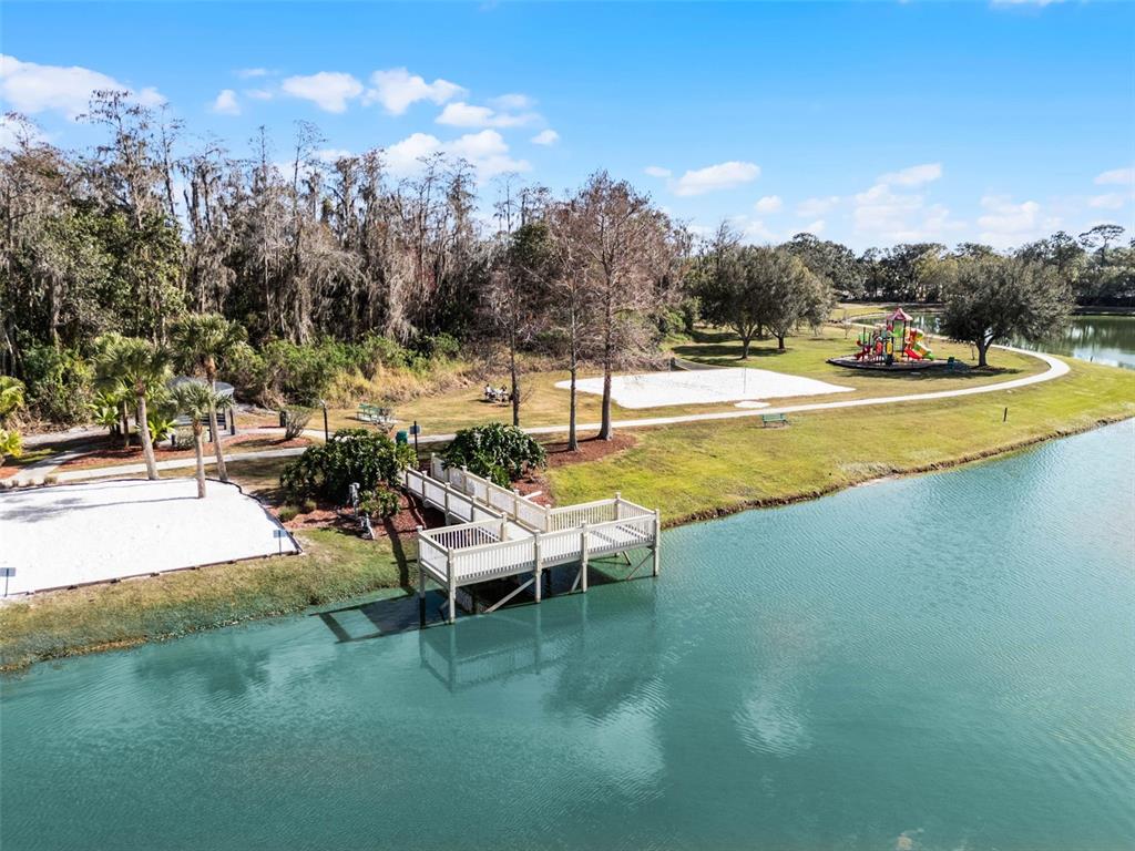 1086 Park Ridge Circle Kissimmee, FL 34746 - Photo 55 of 57 a view of a swimming pool with outdoor seating and a garden
