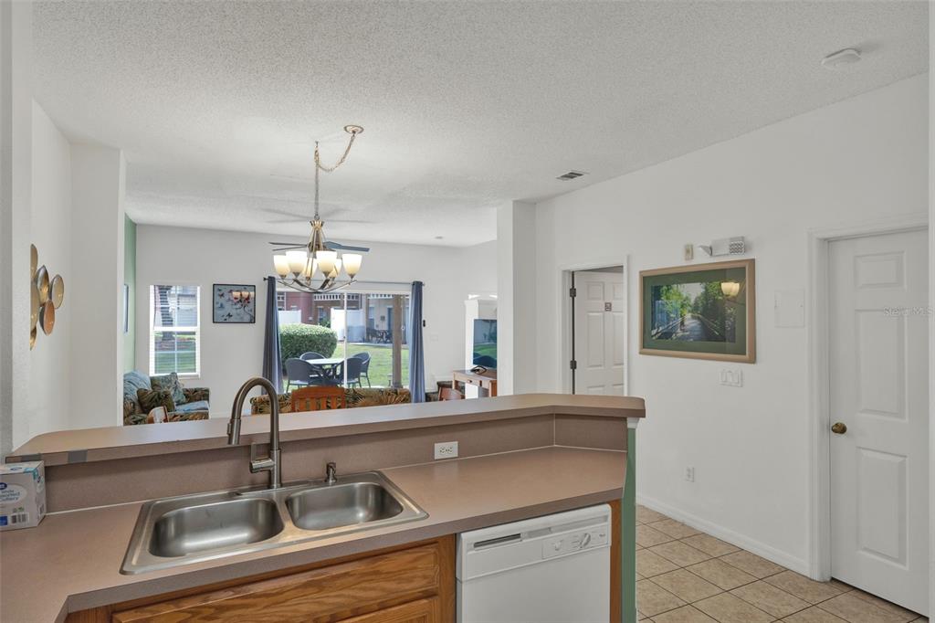 1086 Park Ridge Circle Kissimmee, FL 34746 - Photo 8 of 57 a kitchen with a sink and a refrigerator