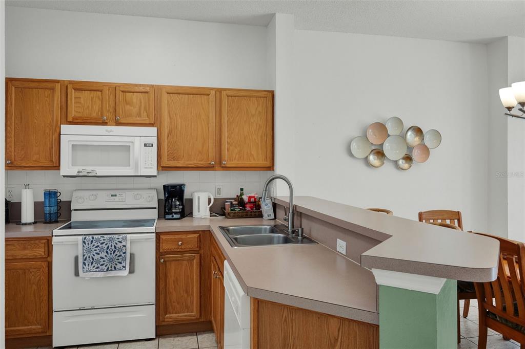 1086 Park Ridge Circle Kissimmee, FL 34746 - Photo 9 of 57 a kitchen with a sink a stove and cabinets