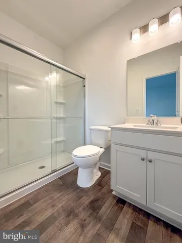 a bathroom with a toilet sink and a mirror