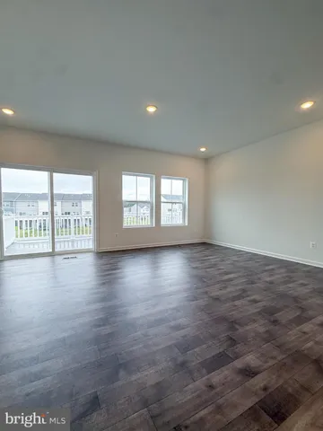 an empty room with large windows