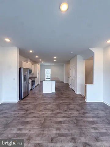 a large kitchen with granite countertop a large counter top stainless steel appliances and cabinets