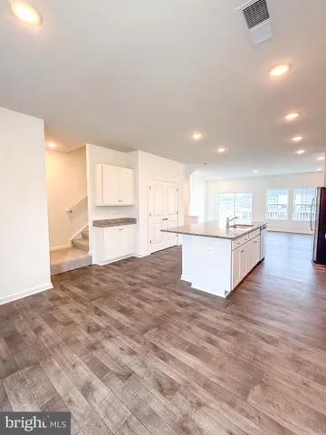 a view of an empty room and wooden floor