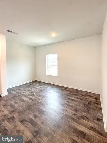 a view of a kitchen with wooden floor and a sink