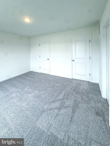 a room with a wooden floor and entryway