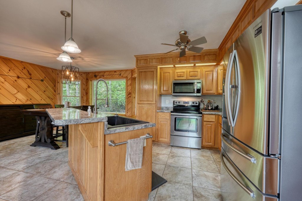 520 Brasstown Road Murphy, NC 28906 - Photo 18 of 61 a kitchen with stainless steel appliances granite countertop a refrigerator a stove top oven a sink and dishwasher