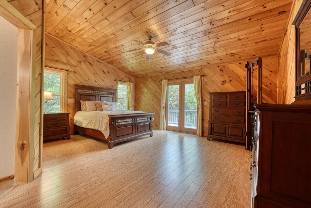 520 Brasstown Road Murphy, NC 28906 - Photo 5 of 61 a bedroom with a bed and wooden floor