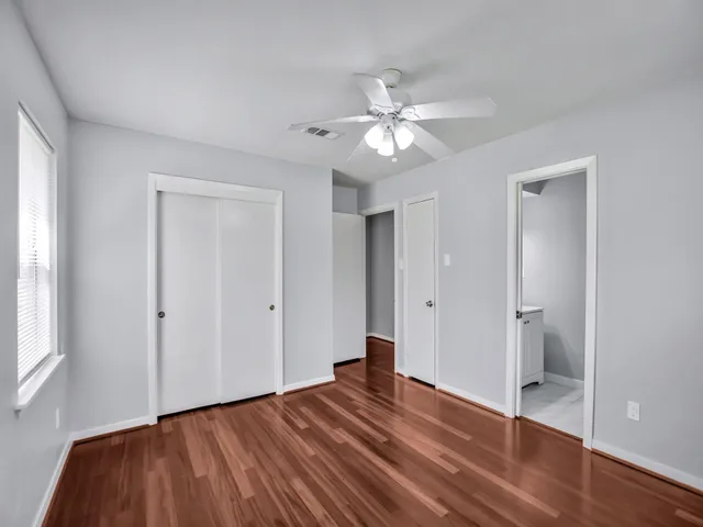 a view of empty room with wooden floor