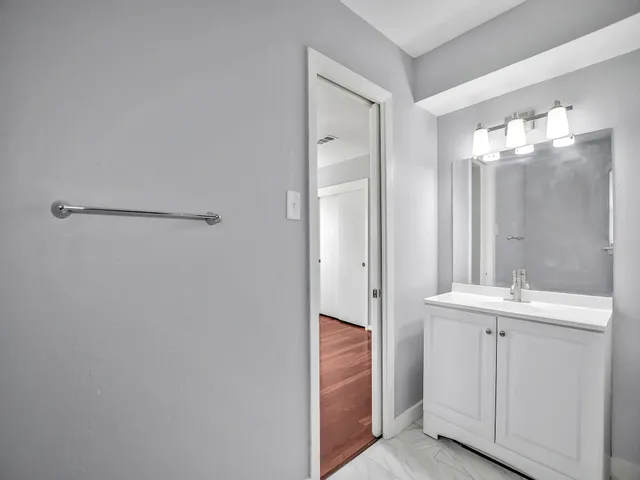 a bathroom with a double vanity sink a toilet and a mirror