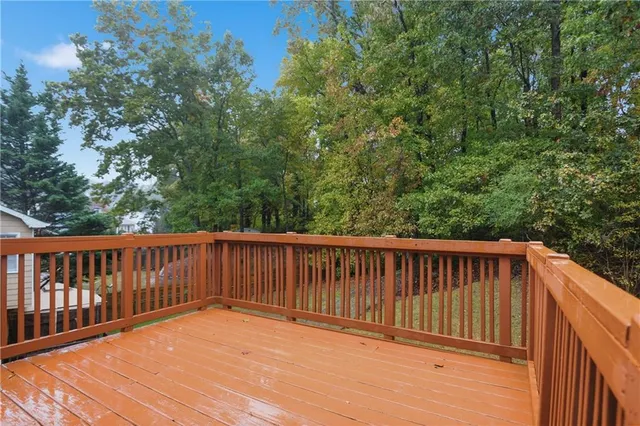 a balcony with wooden floor and fence