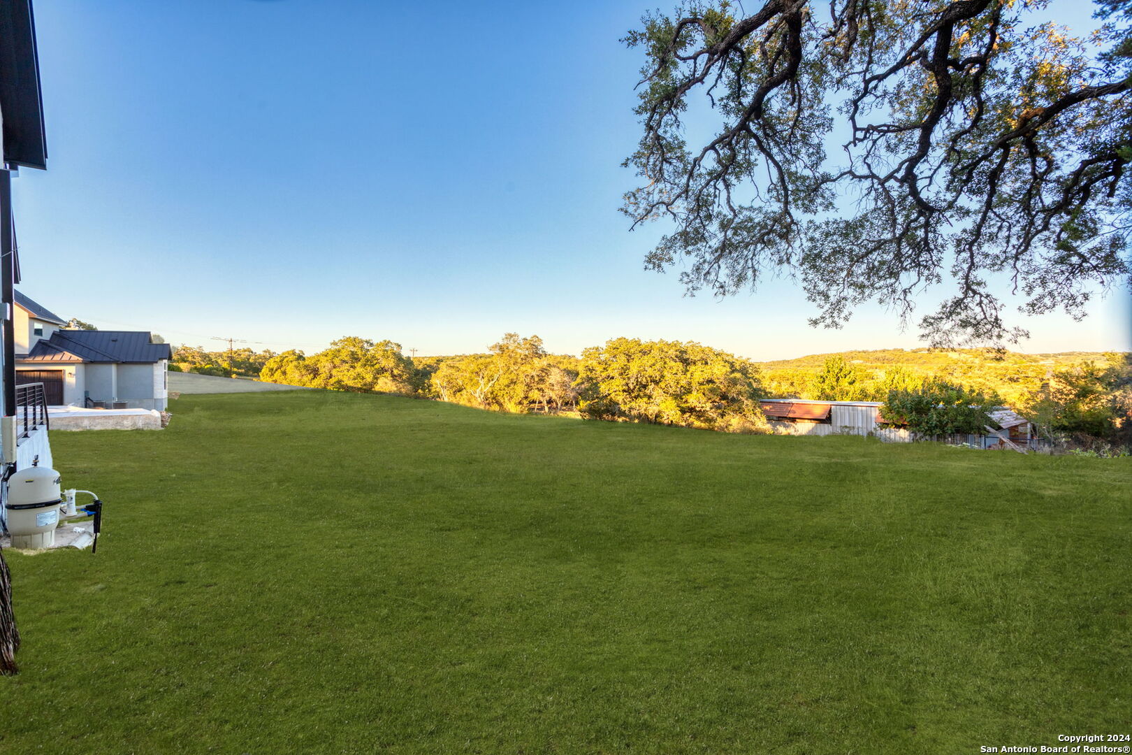3079 Campestres Spring Branch, TX 78070 - Photo 37 of 38 a view of a grassy field with an trees