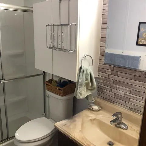 a bathroom with a glass shower door