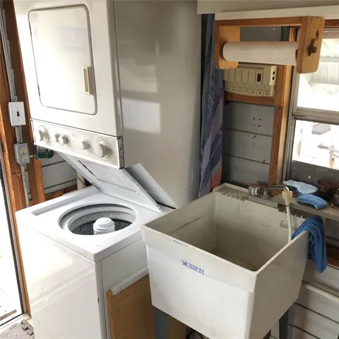 a view of a white house with a yard and garage