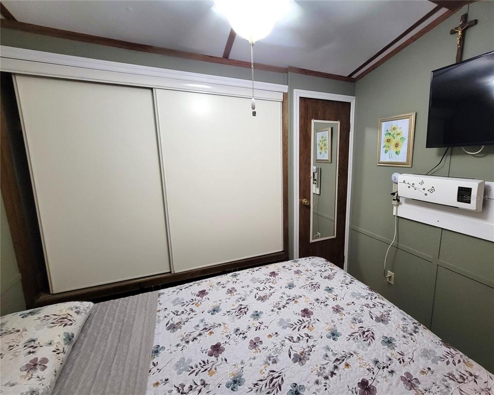 1424 Trout Punta Gorda, FL 33950 - Photo 18 of 32 a bedroom with a bed and a flat screen tv