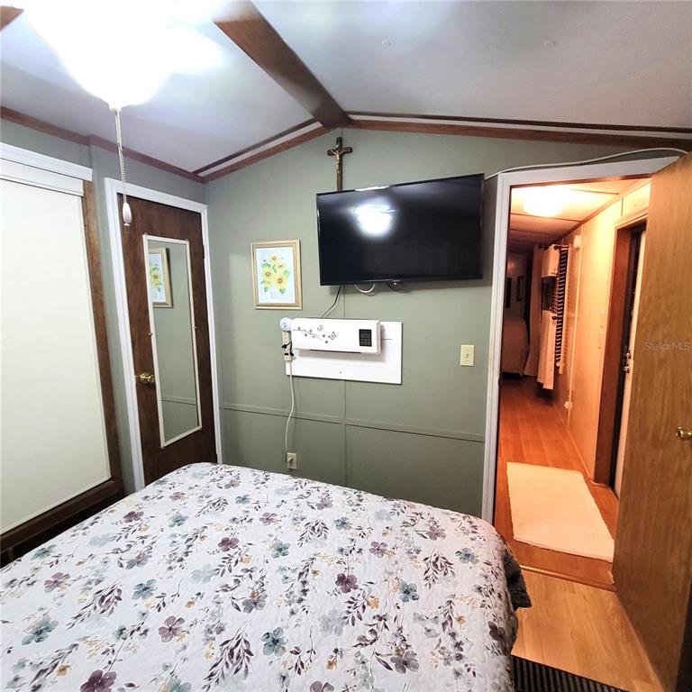 1424 Trout Punta Gorda, FL 33950 - Photo 20 of 32 a bedroom with a bed and a flat screen tv