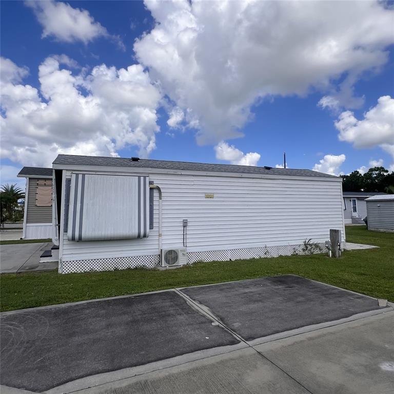 1424 Trout Punta Gorda, FL 33950 - Photo 24 of 32 a front view of a house with a yard and garage