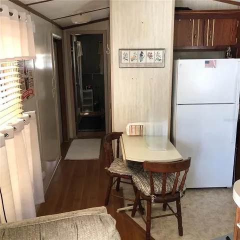a view of a kitchen with furniture and wooden floor