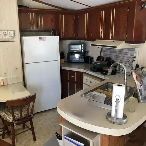 a kitchen with a refrigerator and a sink