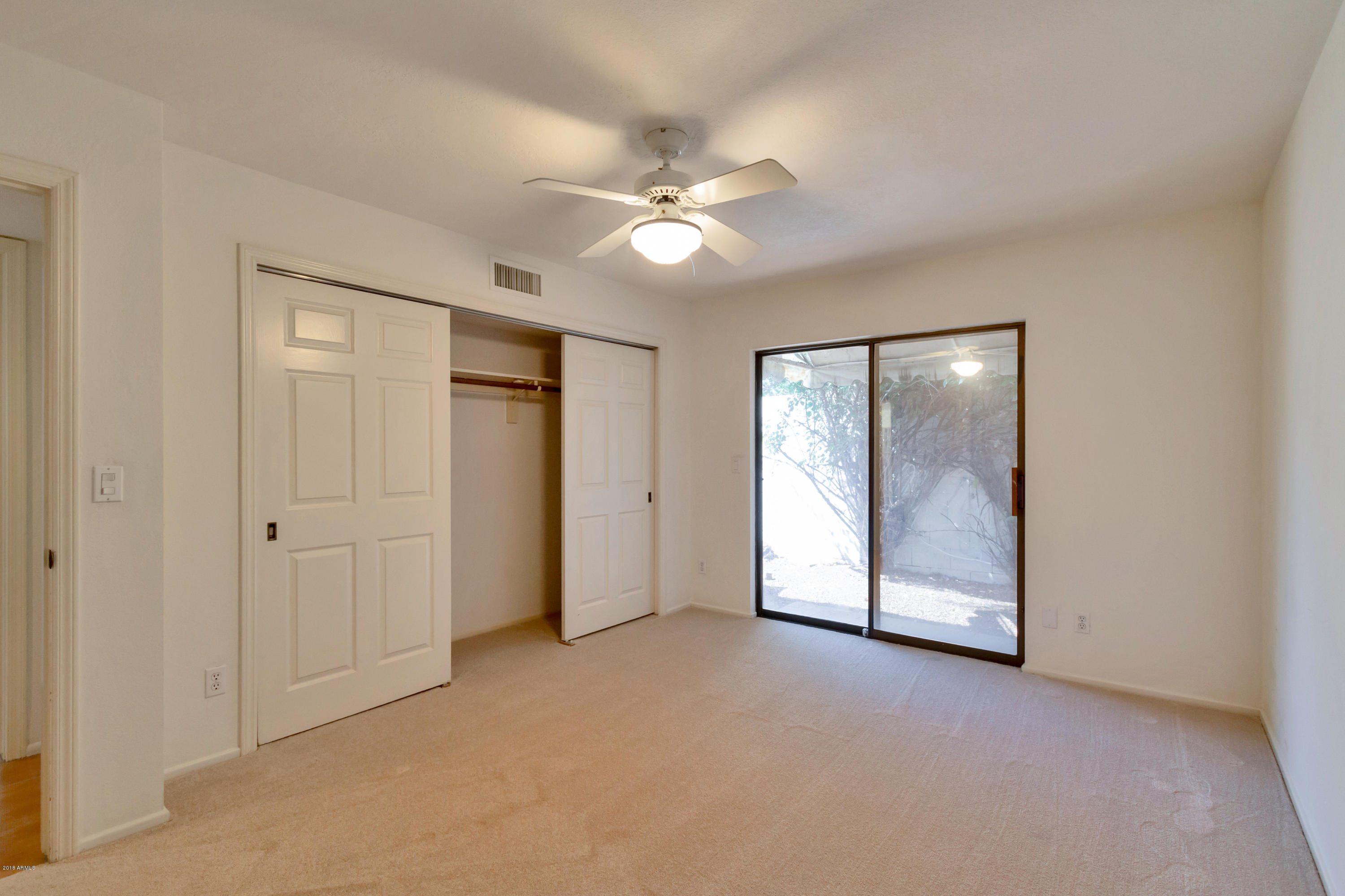 5310 North 24th Place Phoenix, AZ 85016 - Photo 18 of 21 an empty room with closet and a ceiling fan