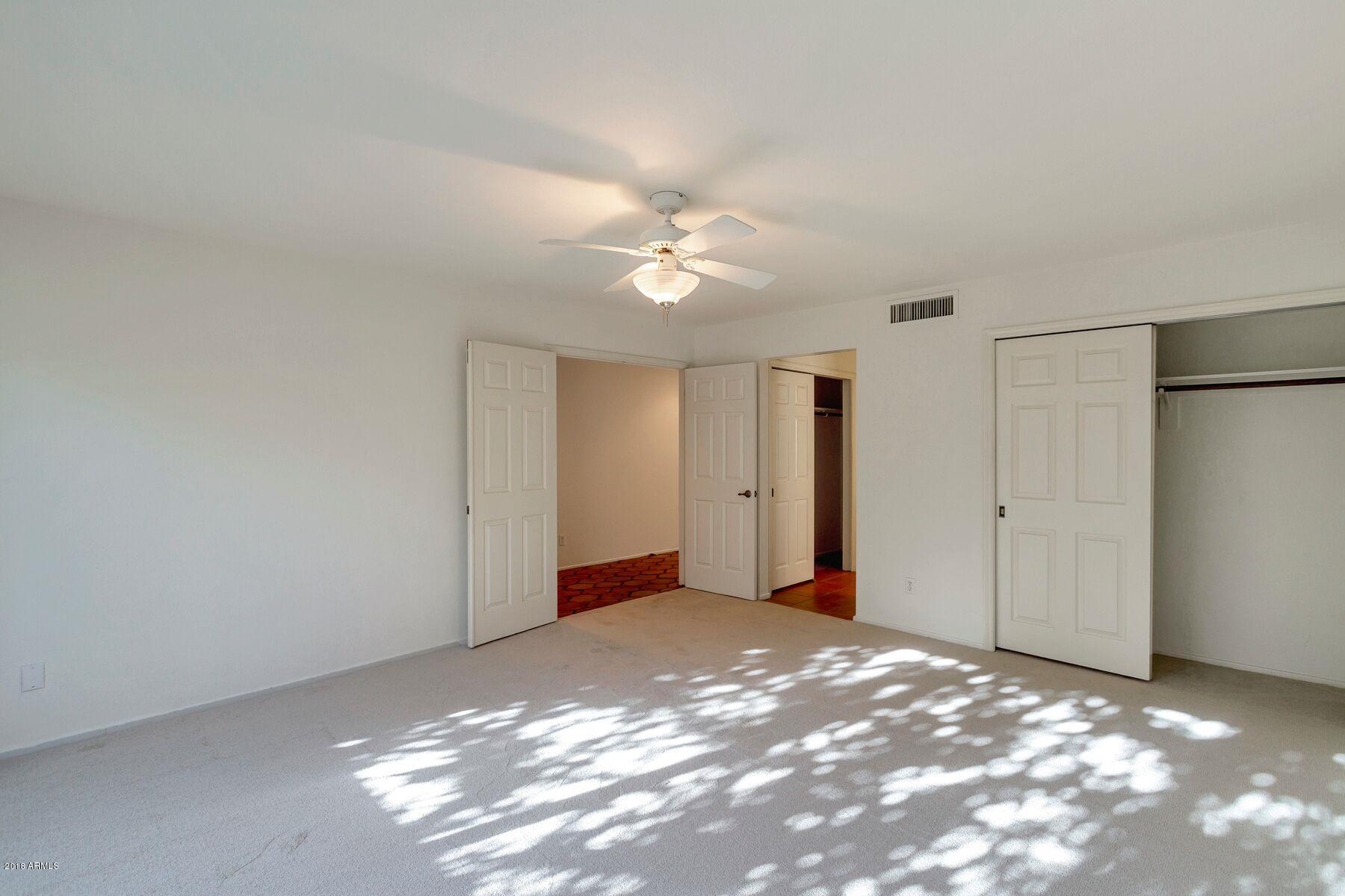 5310 North 24th Place Phoenix, AZ 85016 - Photo 5 of 21 a view of a big room with closet and a ceiling fan