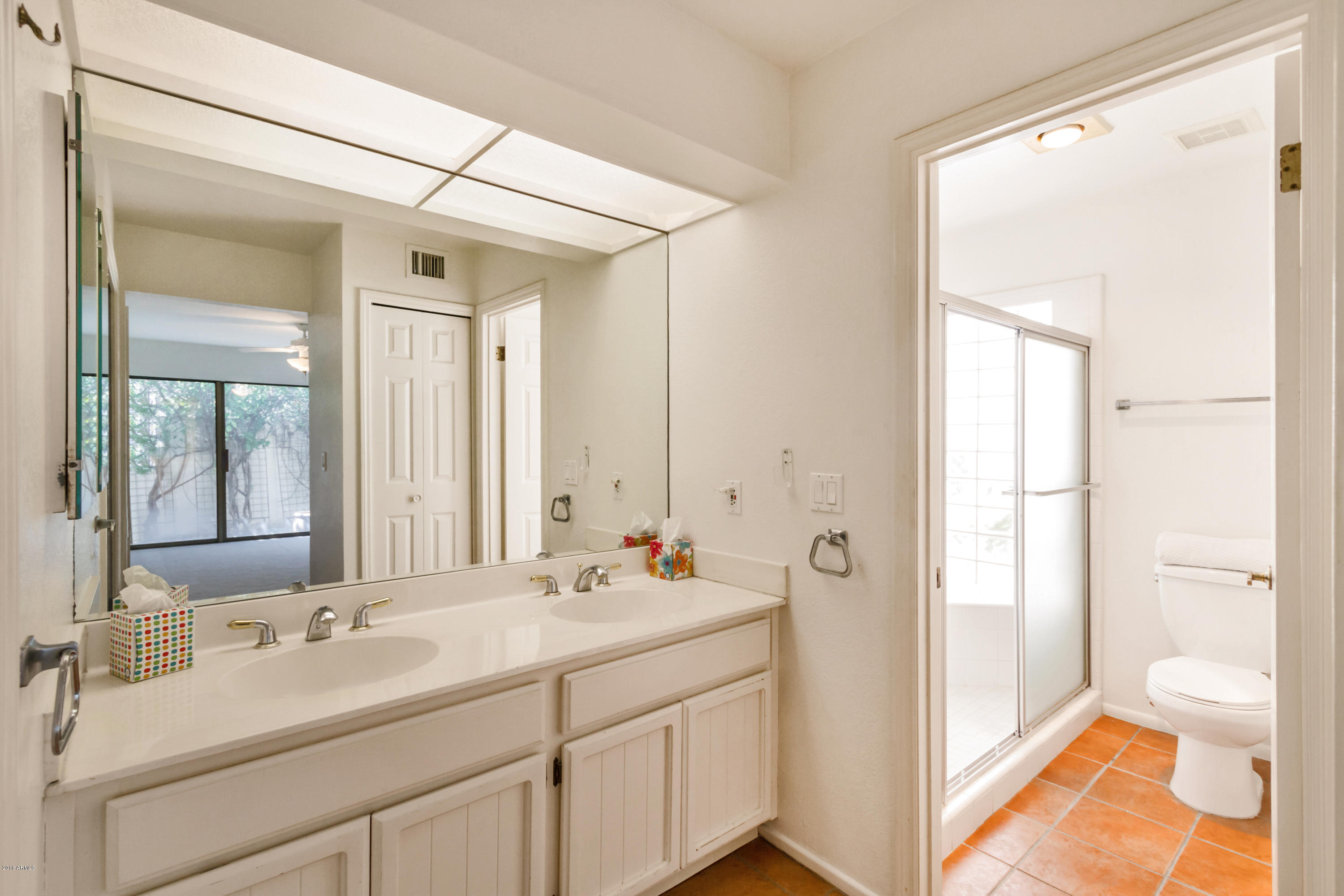 5310 North 24th Place Phoenix, AZ 85016 - Photo 9 of 21 a bathroom with a double vanity sink mirror and next to a window