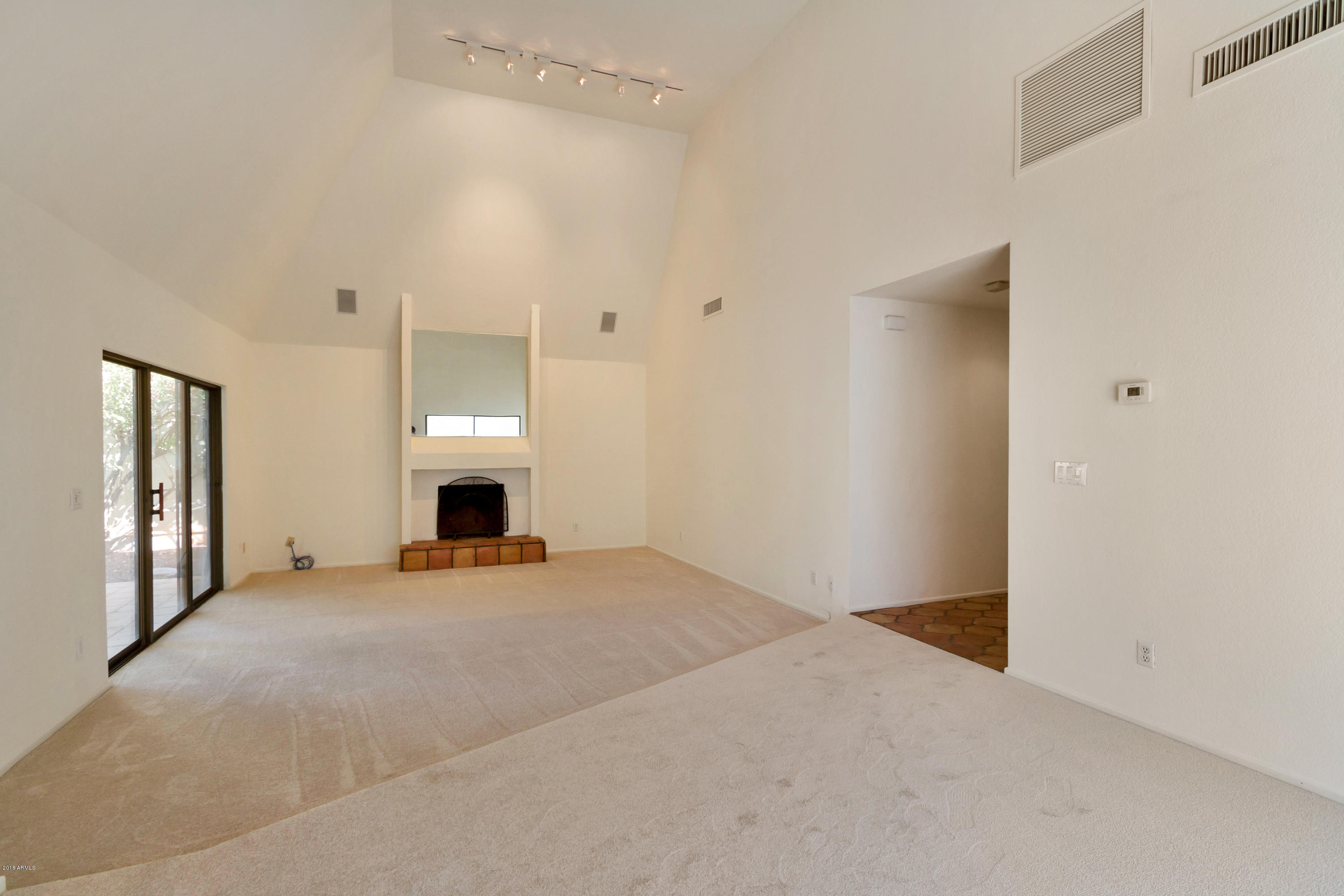 5310 North 24th Place Phoenix, AZ 85016 - Photo 10 of 21 a view of an empty room with window and fireplace