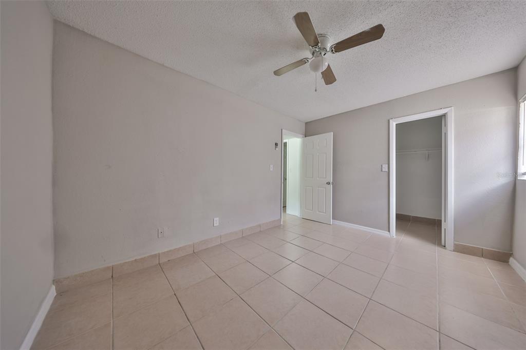 11708 Balm Riverview Road Riverview, FL 33569 - Photo 34 of 37 an empty room with closet and ceiling fan