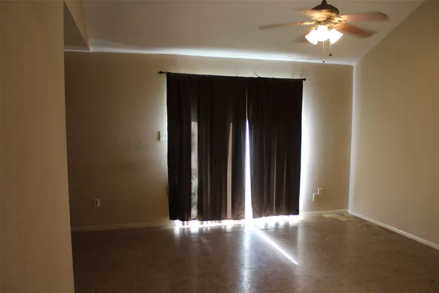a view of a livingroom with a chandelier fan