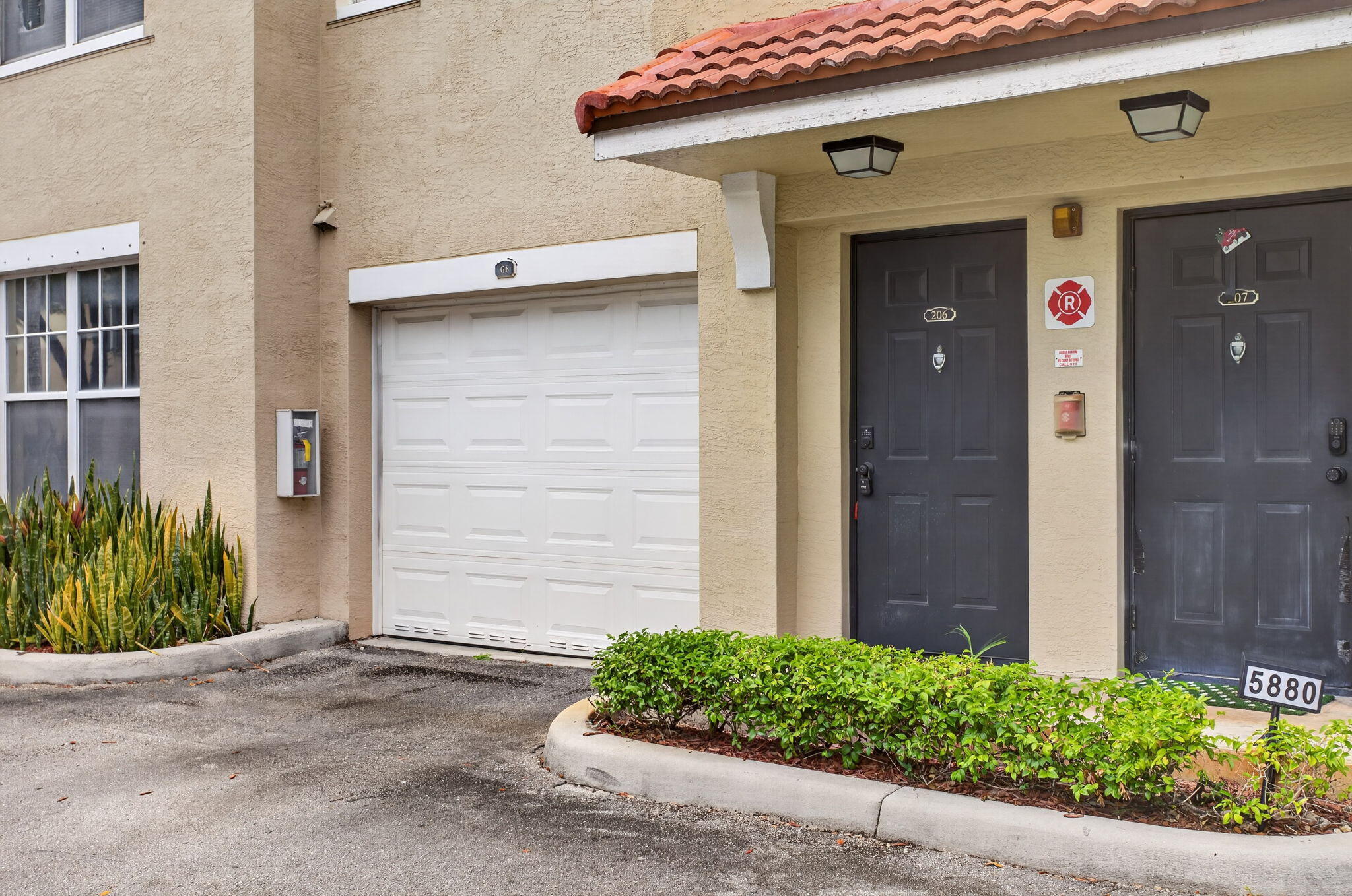 5880 West Sample Road, Unit 206 Coral Springs, FL 33067 - Photo 4 of 37 a front view of a house with garden