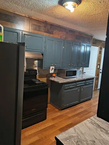 a kitchen with granite countertop stainless steel appliances and wooden cabinets