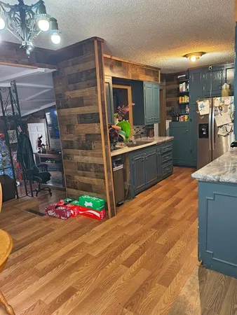 a kitchen with granite countertop a stove and cabinets