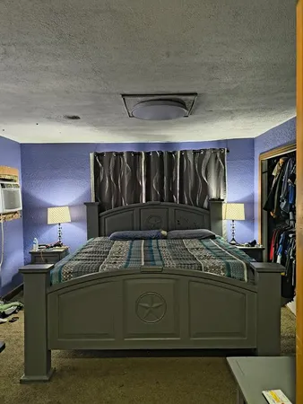 a bedroom with a bed and a mirror