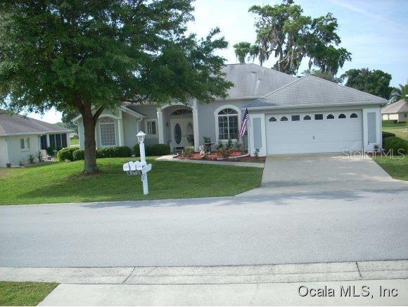 5340 Northwest 25th Loop Ocala, FL 34482 - Photo 1 of 1 a front view of a house with a yard and garage