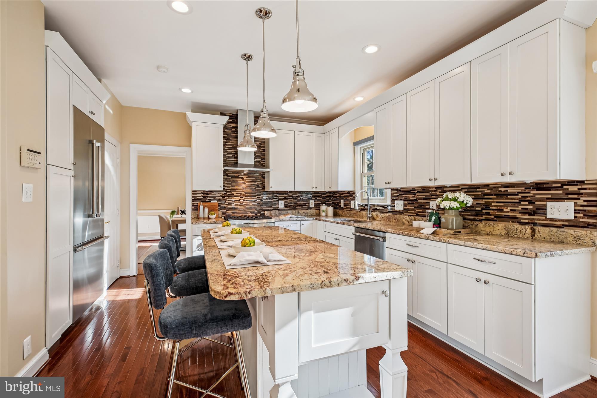 10606 Maplecrest Lane Potomac, MD 20854 - Photo 14 of 47 a kitchen with stainless steel appliances granite countertop a stove a sink a refrigerator and white cabinets with wooden floor