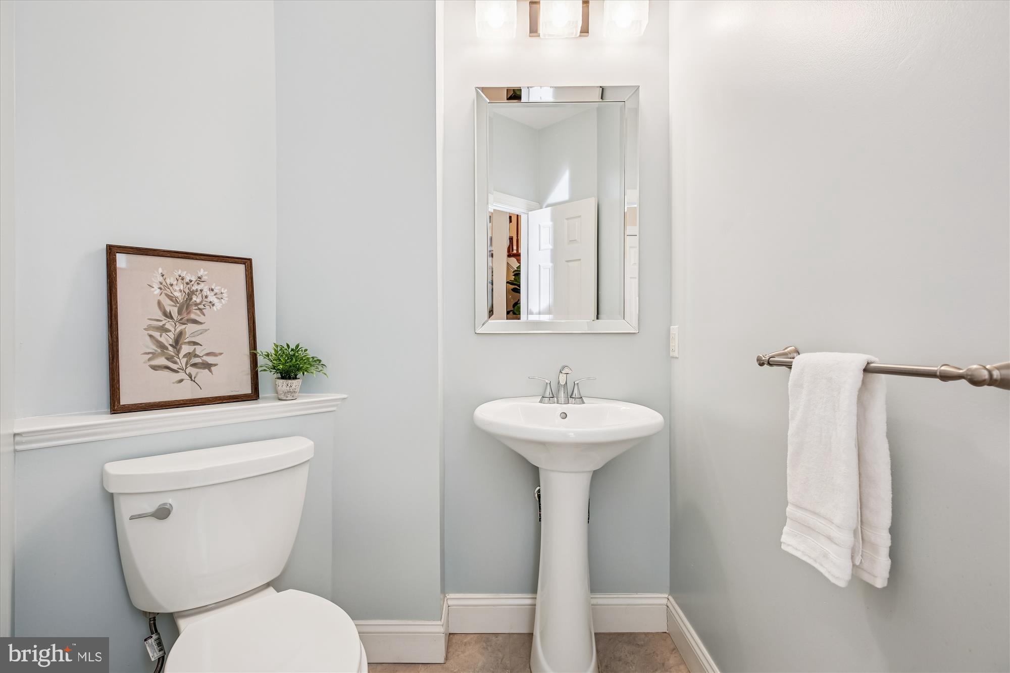 10606 Maplecrest Lane Potomac, MD 20854 - Photo 18 of 47 a bathroom with a toilet sink and mirror