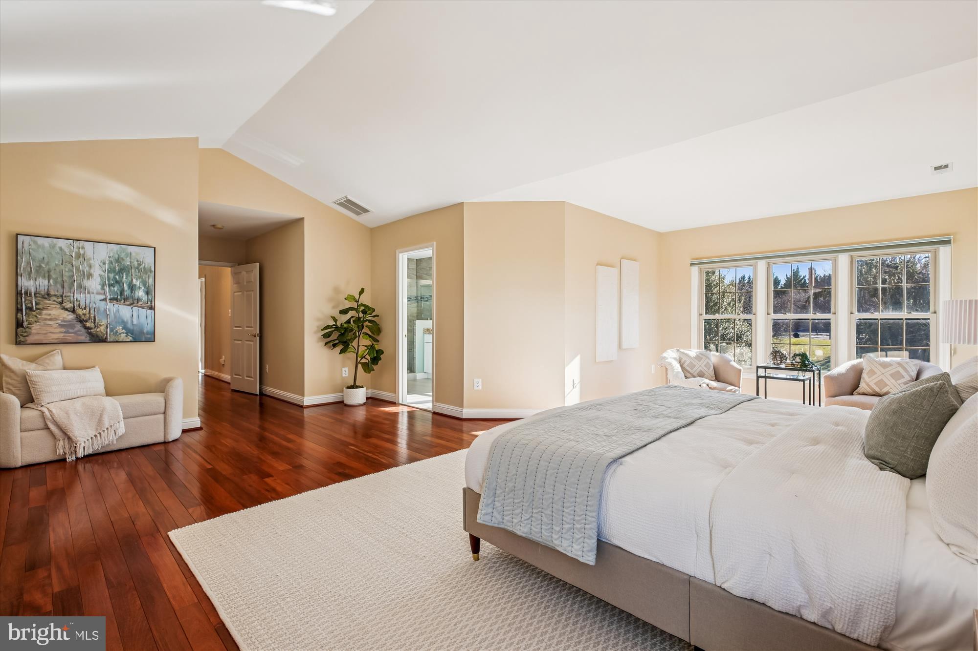 10606 Maplecrest Lane Potomac, MD 20854 - Photo 22 of 47 a spacious bedroom with a large bed and a wooden floor