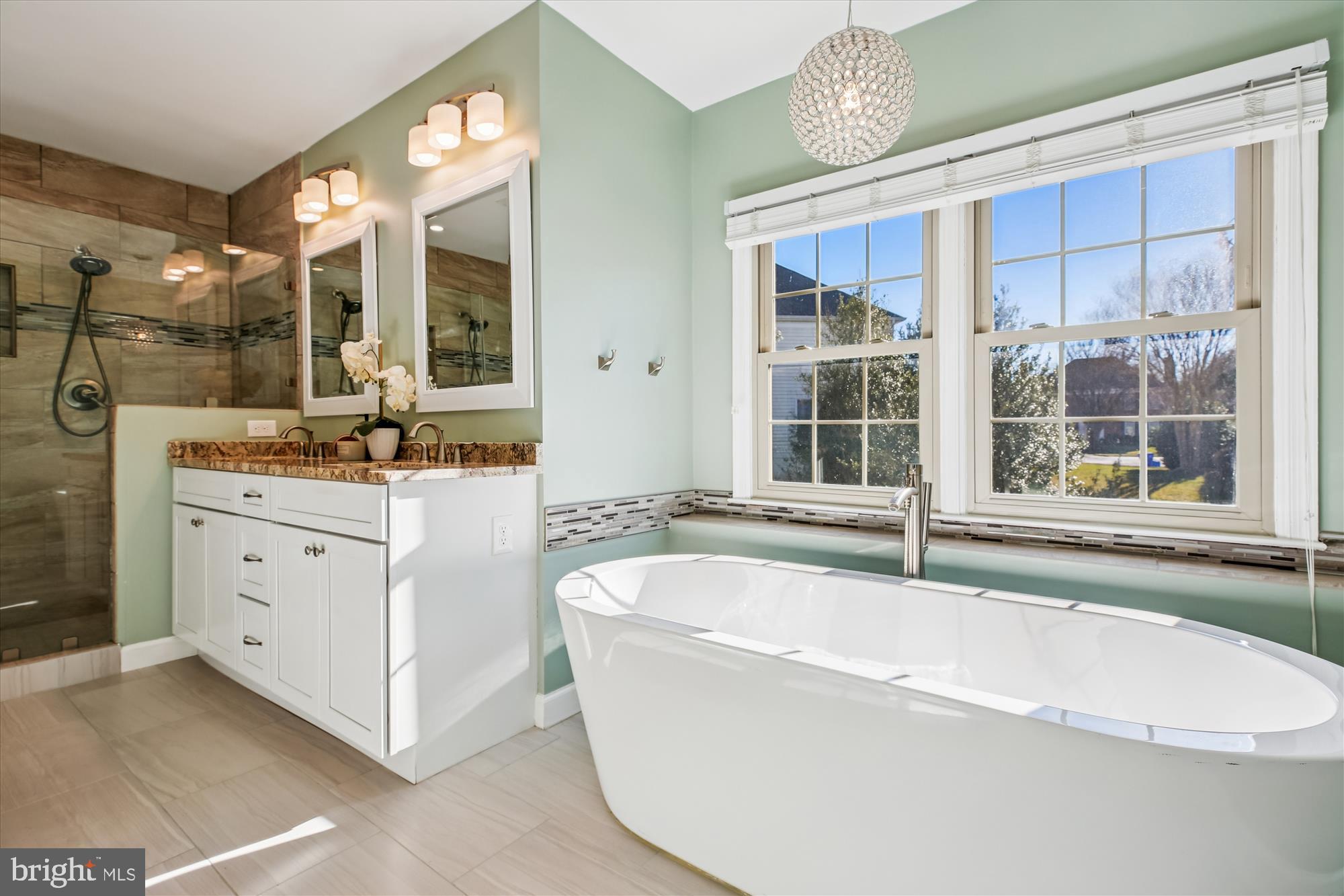 10606 Maplecrest Lane Potomac, MD 20854 - Photo 24 of 47 a bathroom with a tub a sink and a large mirror