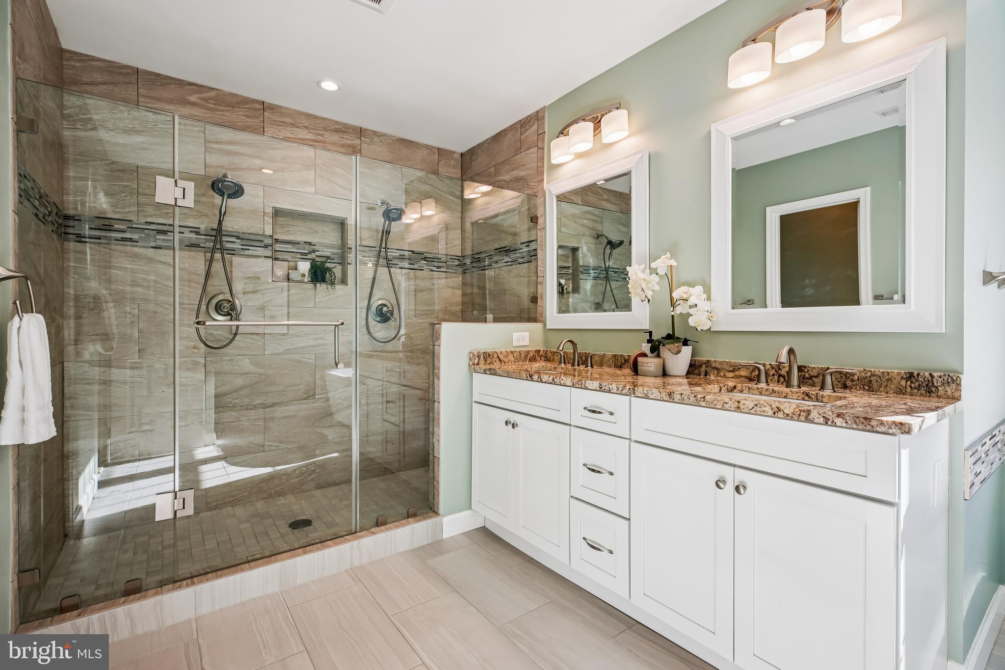10606 Maplecrest Lane Potomac, MD 20854 - Photo 25 of 47 a bathroom with a shower sink and mirror