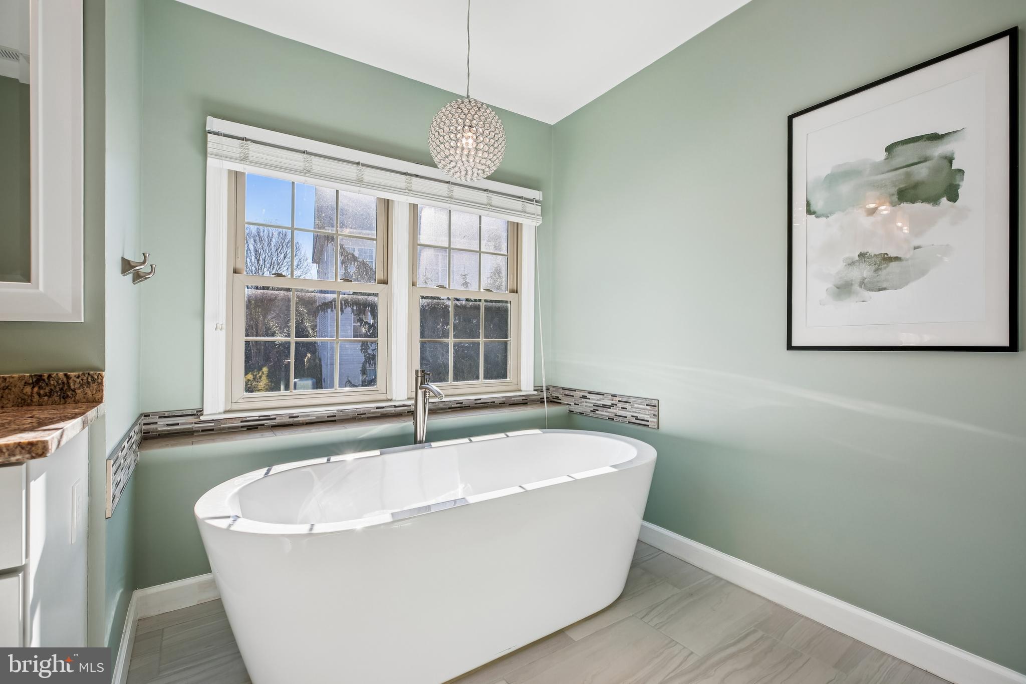 10606 Maplecrest Lane Potomac, MD 20854 - Photo 27 of 47 a white bath tub sitting in a bathroom next to a window
