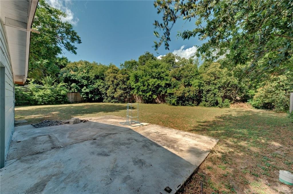 8318 Burrell Drive Austin, TX 78757 - Photo 27 of 27 View of grassy yard featuring a patio area